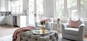 A living room with grey and pink accent colours.