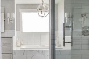 Modern white master bathroom with walk in shower and a soaking tub.