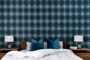 Colourful blue patterned wall paper in a master bedroom.