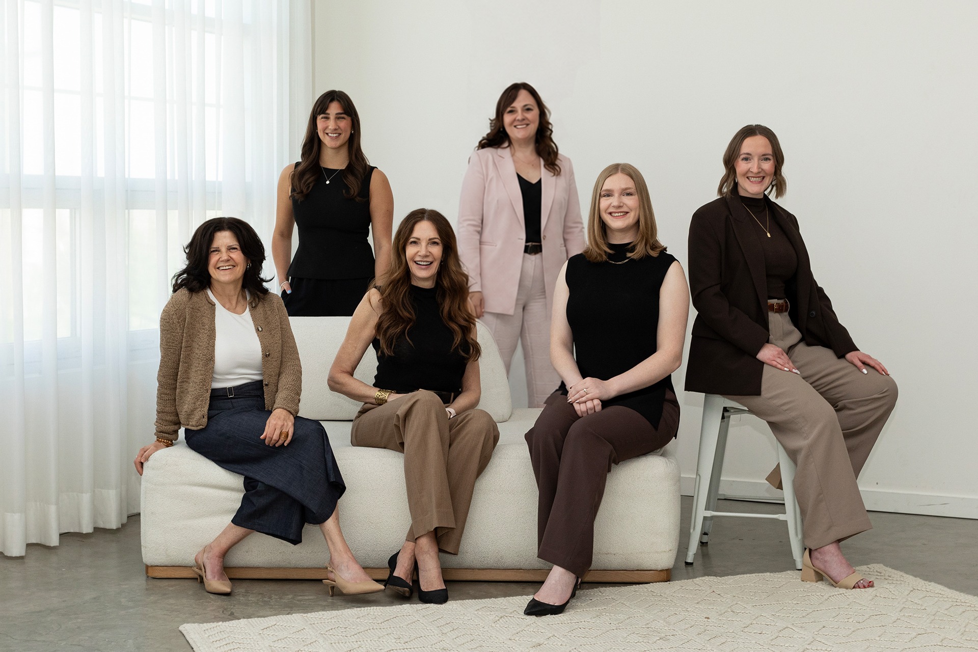 Professional Calgary interior design team posing for a studio portrait.
