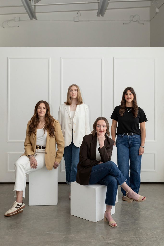 Professional Calgary interior design team posing for a studio portrait.